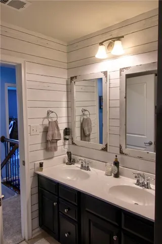 a bathroom with a double vanity sink and a mirror