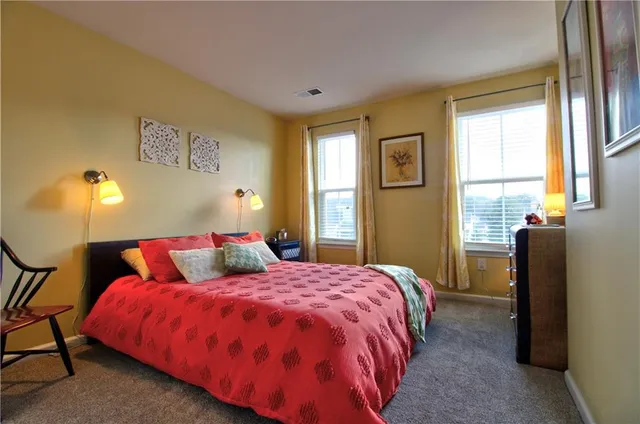 a bedroom with a bed and lamp with window