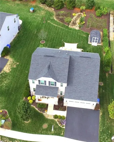 an aerial view of a house with a yard