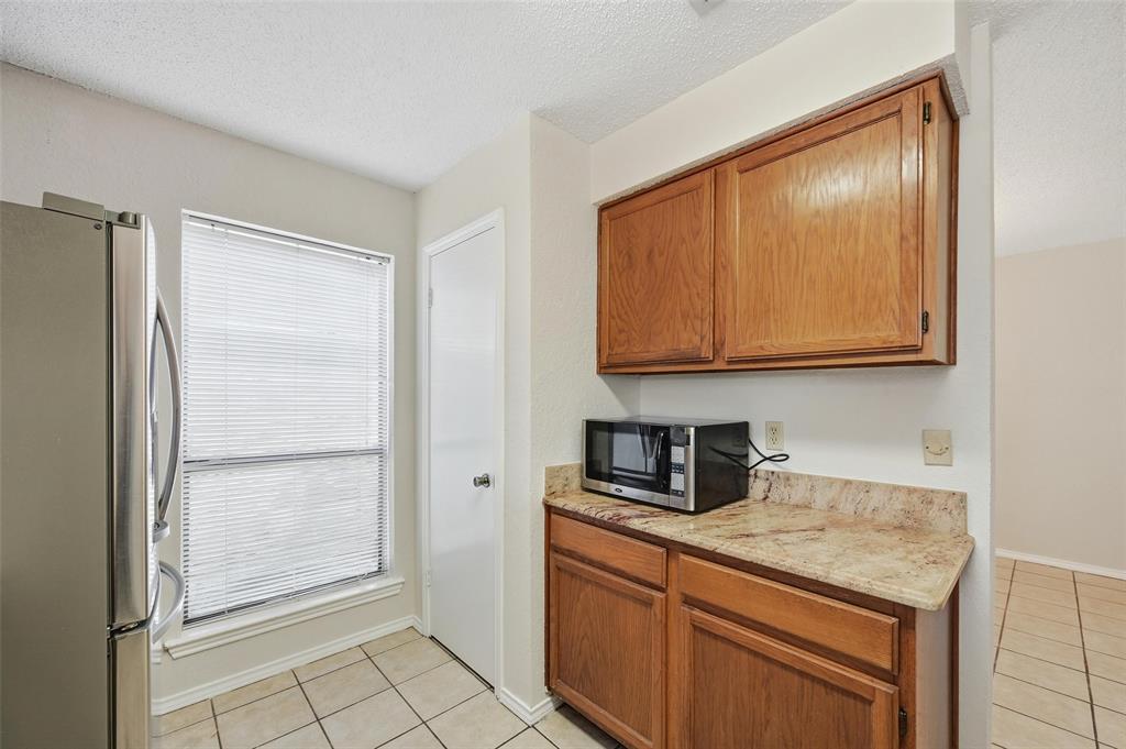 2708 Chisolm Trail Mesquite, TX 75150 - Photo 11 of 28 a kitchen with stainless steel appliances granite countertop a refrigerator and a sink
