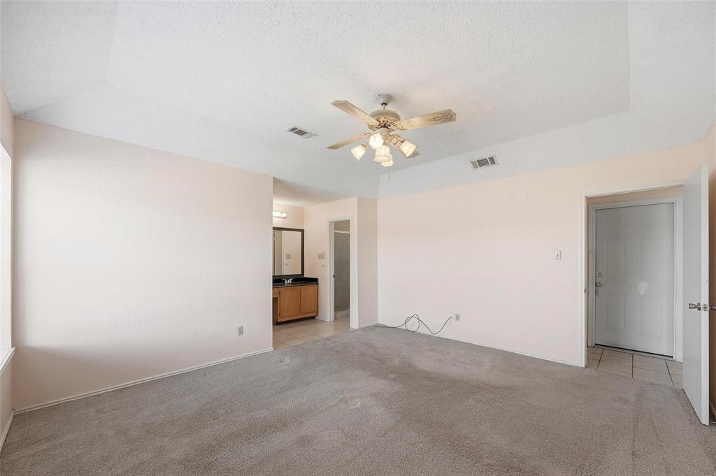 2708 Chisolm Trail Mesquite, TX 75150 - Photo 14 of 28 an empty room with a chandelier fan and windows
