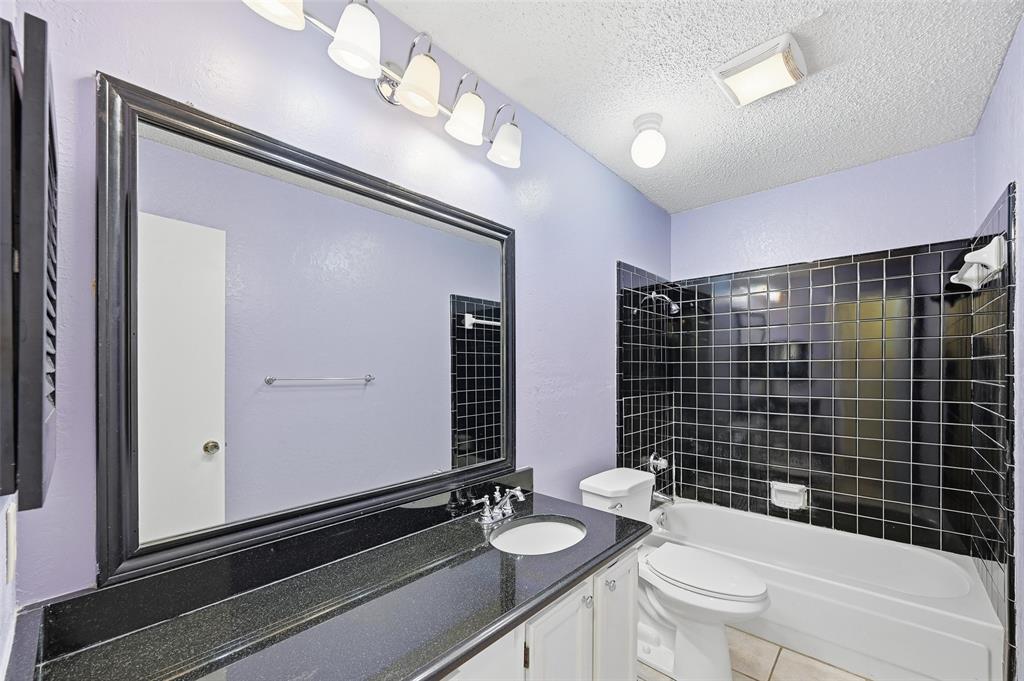 2708 Chisolm Trail Mesquite, TX 75150 - Photo 16 of 28 a bathroom with a granite countertop sink mirror vanity and toilet