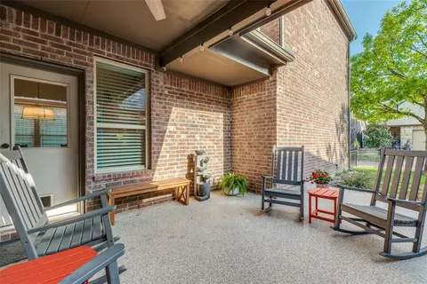 a backyard of a house with table and chairs