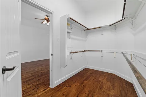 a view of a room with wooden floor and white walls