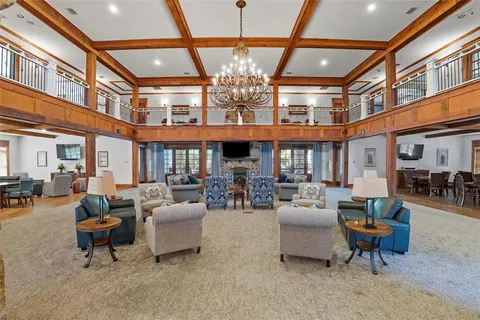 a living room with fireplace furniture and a large window
