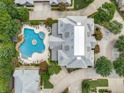 an aerial view of residential houses with outdoor space and street view
