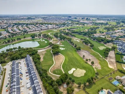an aerial view of a house with a swimming pool yard and outdoor seating