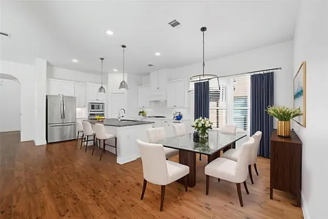 a view of kitchen with refrigerator and microwave