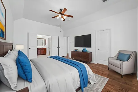 a bedroom with a bed and a flat screen tv