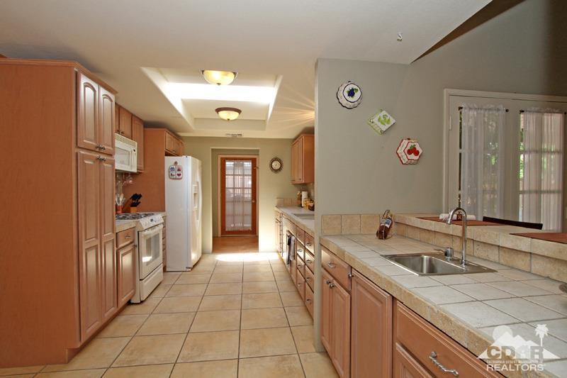 4 Kevin Lee Lane Rancho Mirage, CA 92270 - Photo 12 of 53 a large kitchen with a sink and cabinets