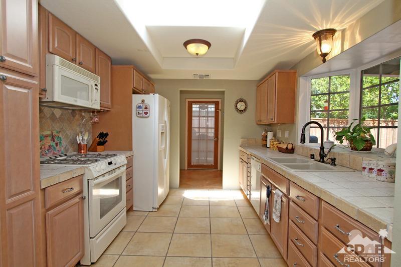 4 Kevin Lee Lane Rancho Mirage, CA 92270 - Photo 13 of 53 a kitchen with a sink cabinets and window