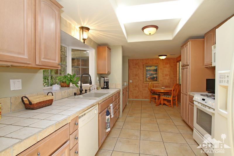 4 Kevin Lee Lane Rancho Mirage, CA 92270 - Photo 15 of 53 a kitchen with stainless steel appliances a sink stove and cabinets