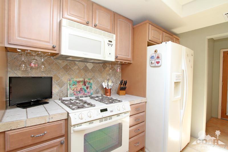 4 Kevin Lee Lane Rancho Mirage, CA 92270 - Photo 16 of 53 a kitchen with a stove and a refrigerator