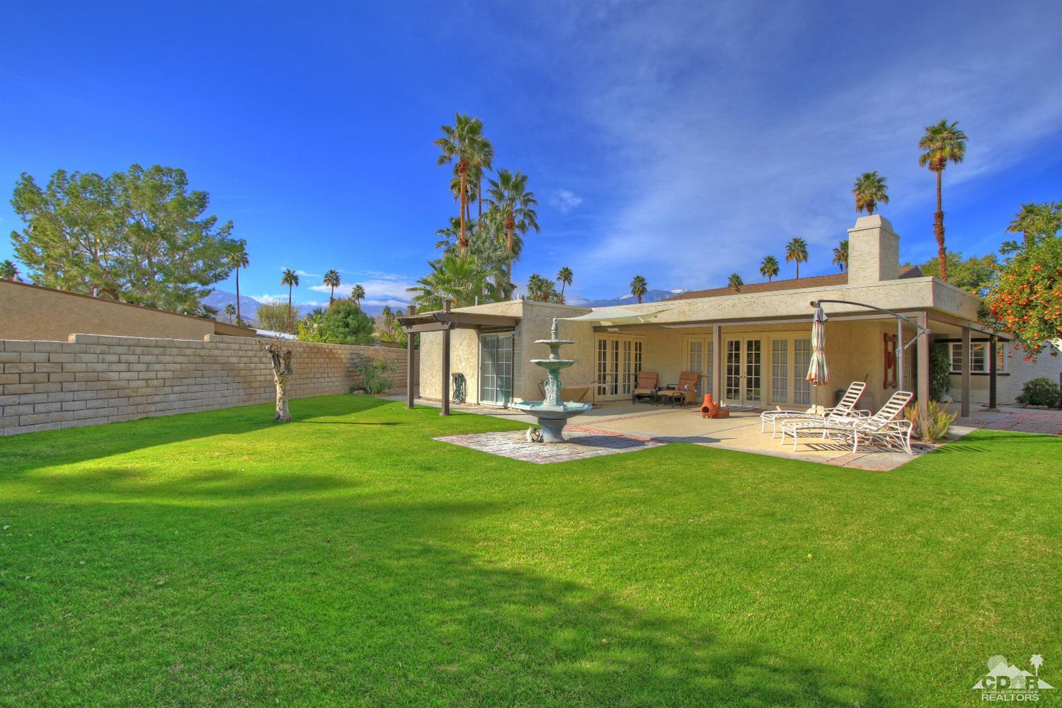 4 Kevin Lee Lane Rancho Mirage, CA 92270 - Photo 2 of 53 a front view of a house with garden fire pit and outdoor seating