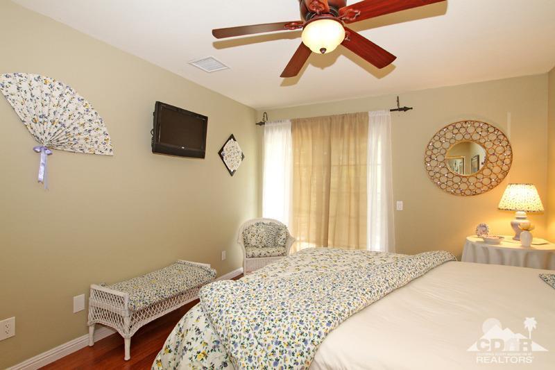 4 Kevin Lee Lane Rancho Mirage, CA 92270 - Photo 34 of 53 a bedroom with a bed and a chandelier