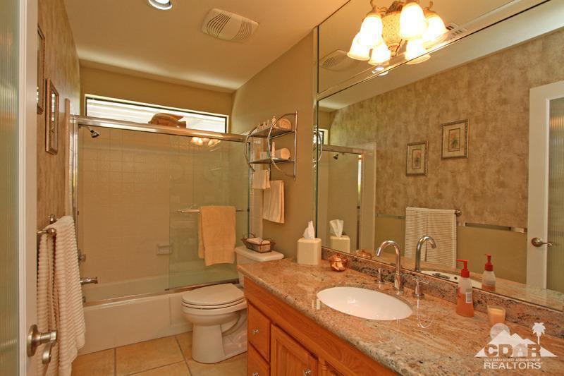 4 Kevin Lee Lane Rancho Mirage, CA 92270 - Photo 35 of 53 a bathroom with a granite countertop sink toilet mirror and shower