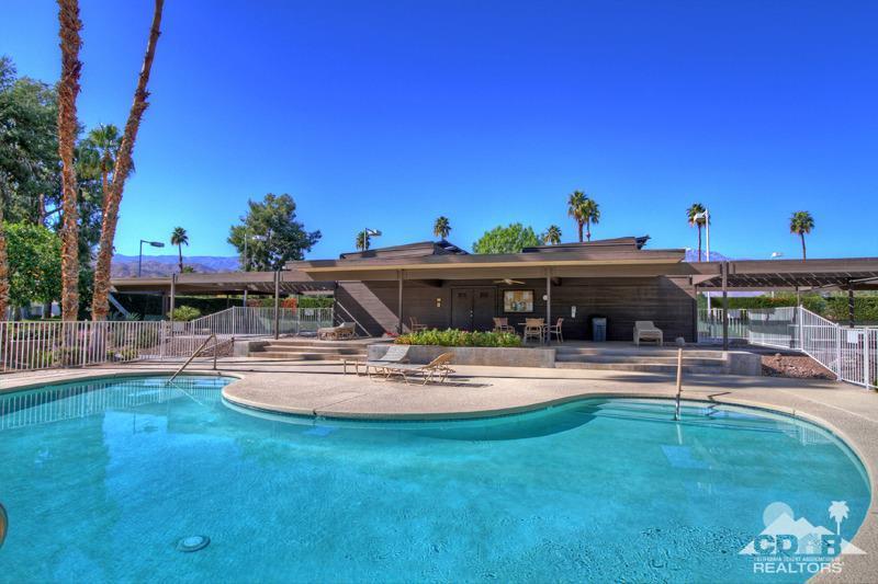 4 Kevin Lee Lane Rancho Mirage, CA 92270 - Photo 49 of 53 a view of a swimming pool with lawn chairs under an umbrella