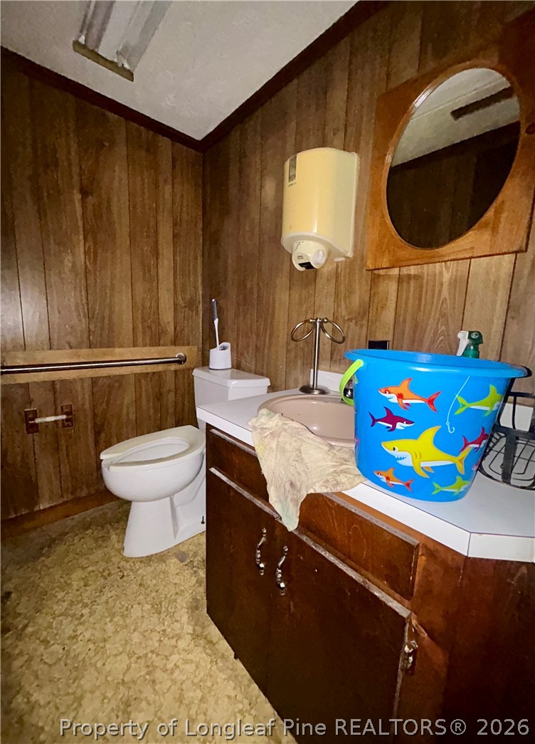918 Opal Road Red Springs, NC 28377 - Photo 7 of 26 a bathroom with a sink mirror vanity and toilet