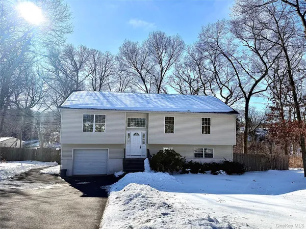 a view of a house with a yard covered in snow