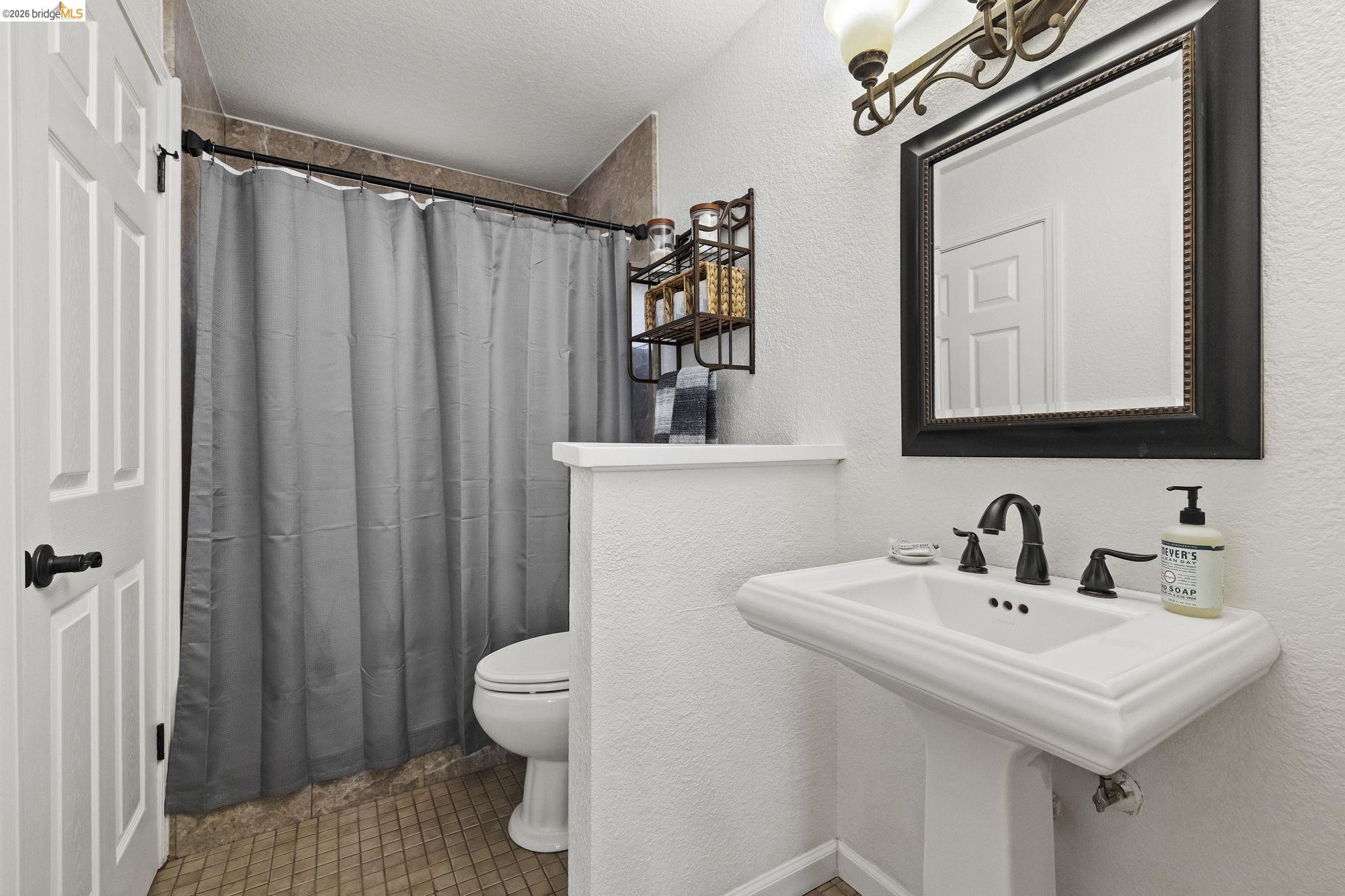 19369 Ferretti Road Groveland, CA 95321 - Photo 18 of 45 Bathroom with a textured wall, a shower with shower curtain, a textured ceiling, and tile patterned flooring