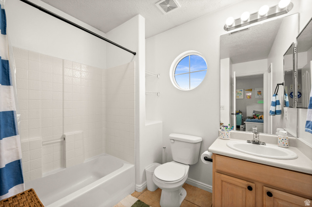 174 Rockey Park Lane, Unit 34 Draper, UT 84020 - Photo 16 of 20 Bathroom with vanity, light tile patterned flooring, a textured ceiling, and shower / tub combo