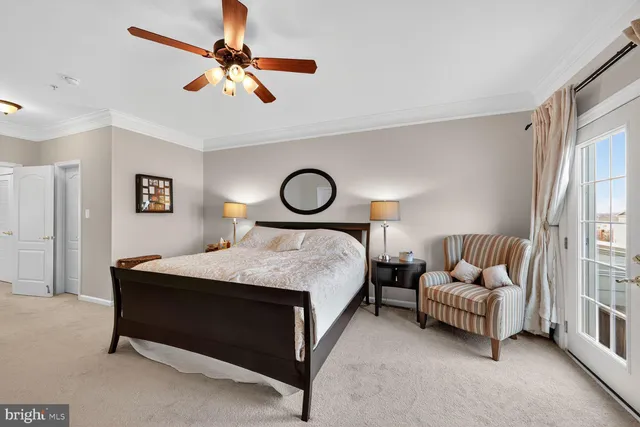 a bedroom with a bed and ceiling fan