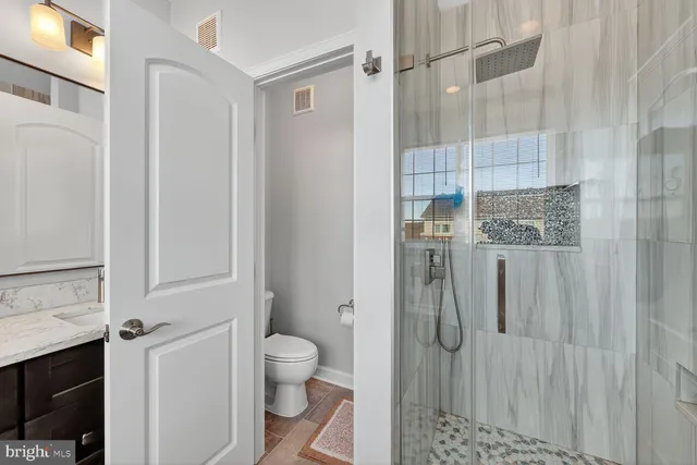 a bathroom with a sink toilet and shower