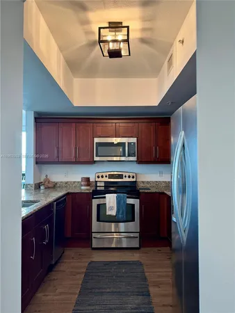 a kitchen with stainless steel appliances granite countertop a stove and a sink