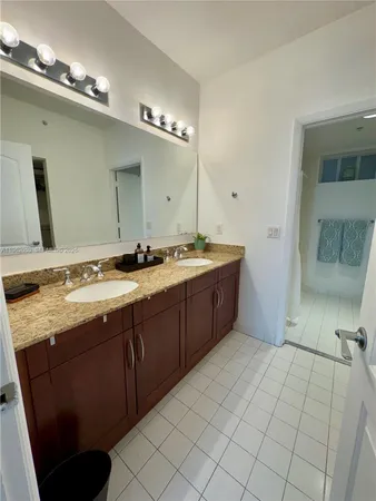 a spacious bathroom with a double vanity sink and a mirror