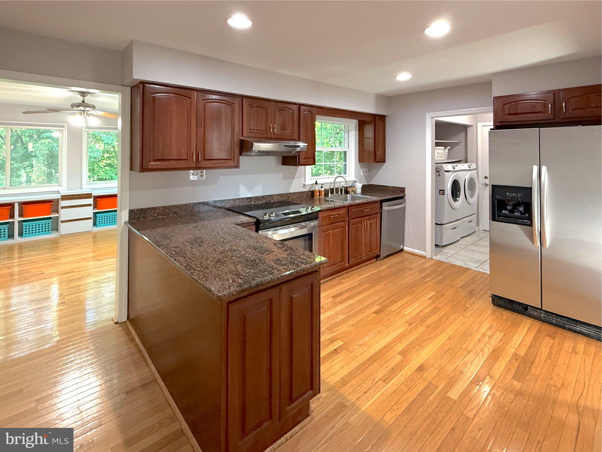 9006 Sidehill Road Ellicott City, MD 21042 - Photo 21 of 53 Modern kitchen with warm wood tones.