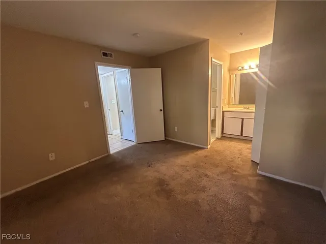 a view of a room with a sink and a mirror