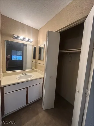 a bathroom with a double vanity sink and mirror