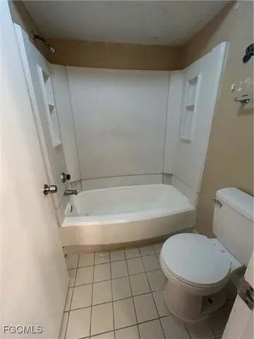 a bathroom with a bathtub and toilet