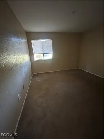 an empty room with a empty space and windows