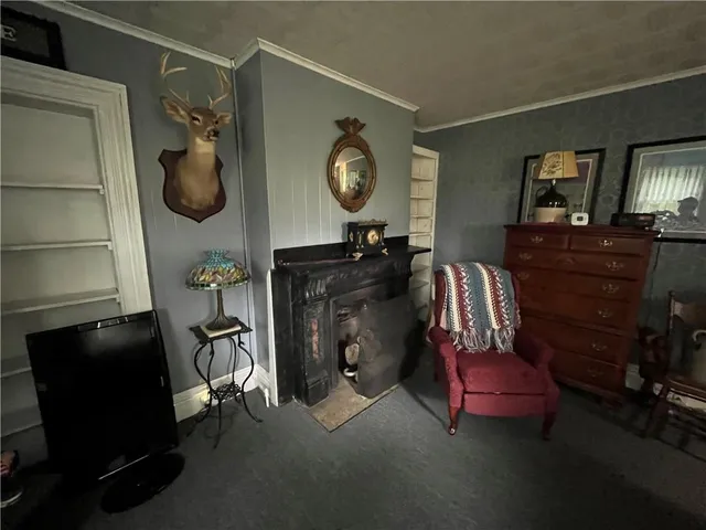 a living room with furniture and a mirror