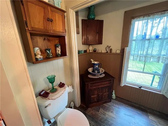 a bathroom with a toilet a sink and a window