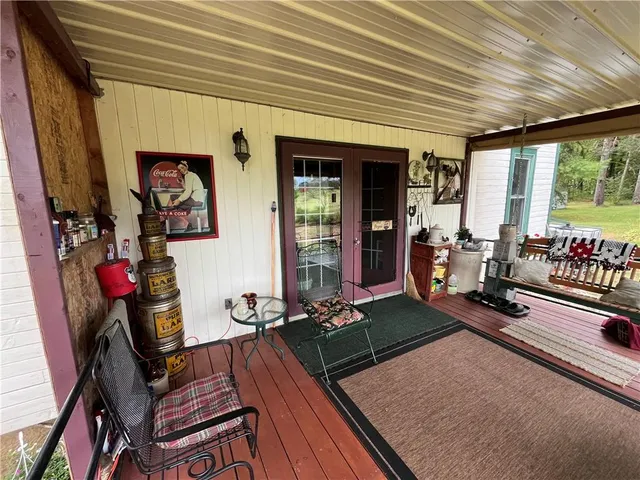 a room with gym equipment and large windows