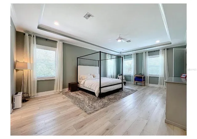 a bedroom with furniture and a window