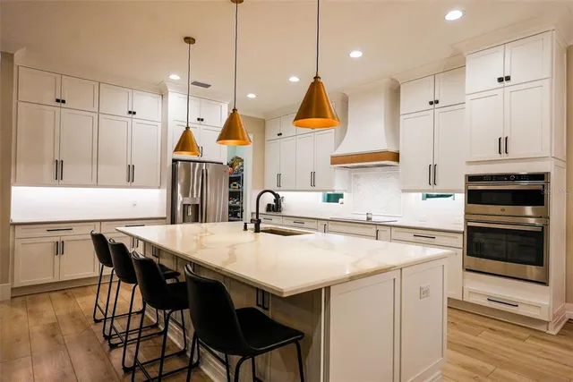 a large kitchen with a table and chairs