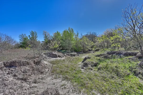 a view of a green field with wooden fence