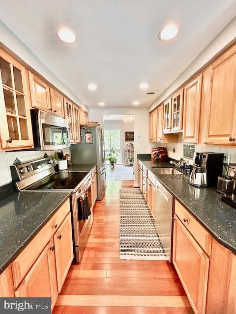 2351 Generation Drive Reston, VA 20191 - Photo 11 of 45 a large kitchen with stainless steel appliances granite countertop a stove top oven a sink dishwasher a dining table and chairs with wooden floor