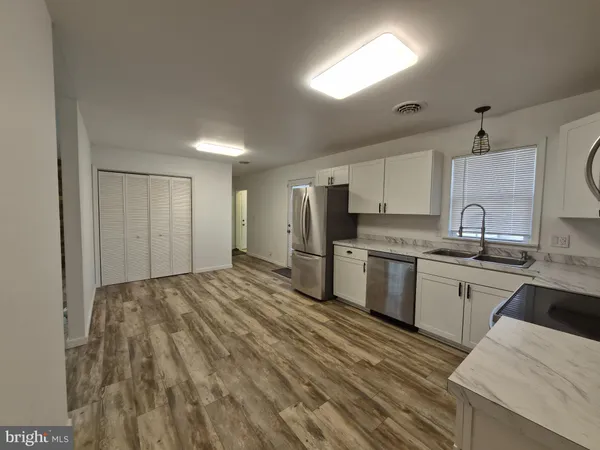 a kitchen with refrigerator cabinets and a sink