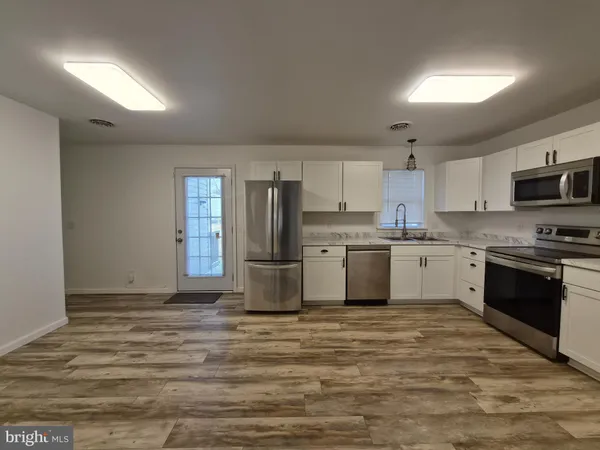 a kitchen with stainless steel appliances cabinets a sink and a window
