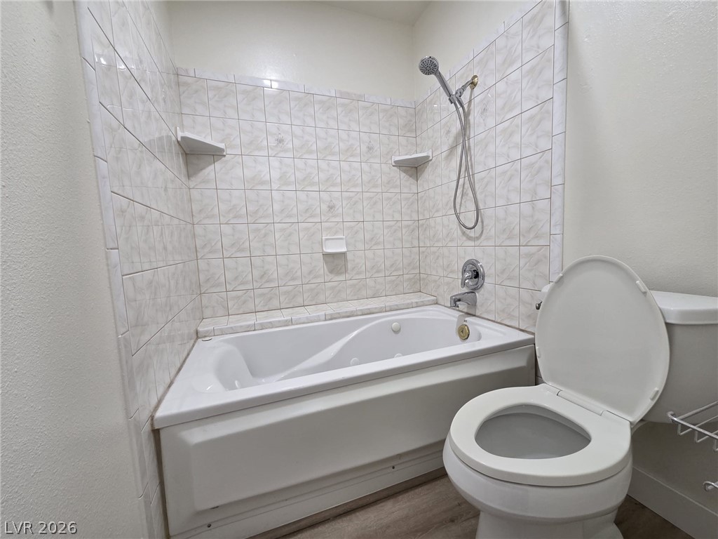 3317 Racquet Street Las Vegas, NV 89121 - Photo 10 of 23 This bathroom features a tiled shower and a spacious soaking tub.