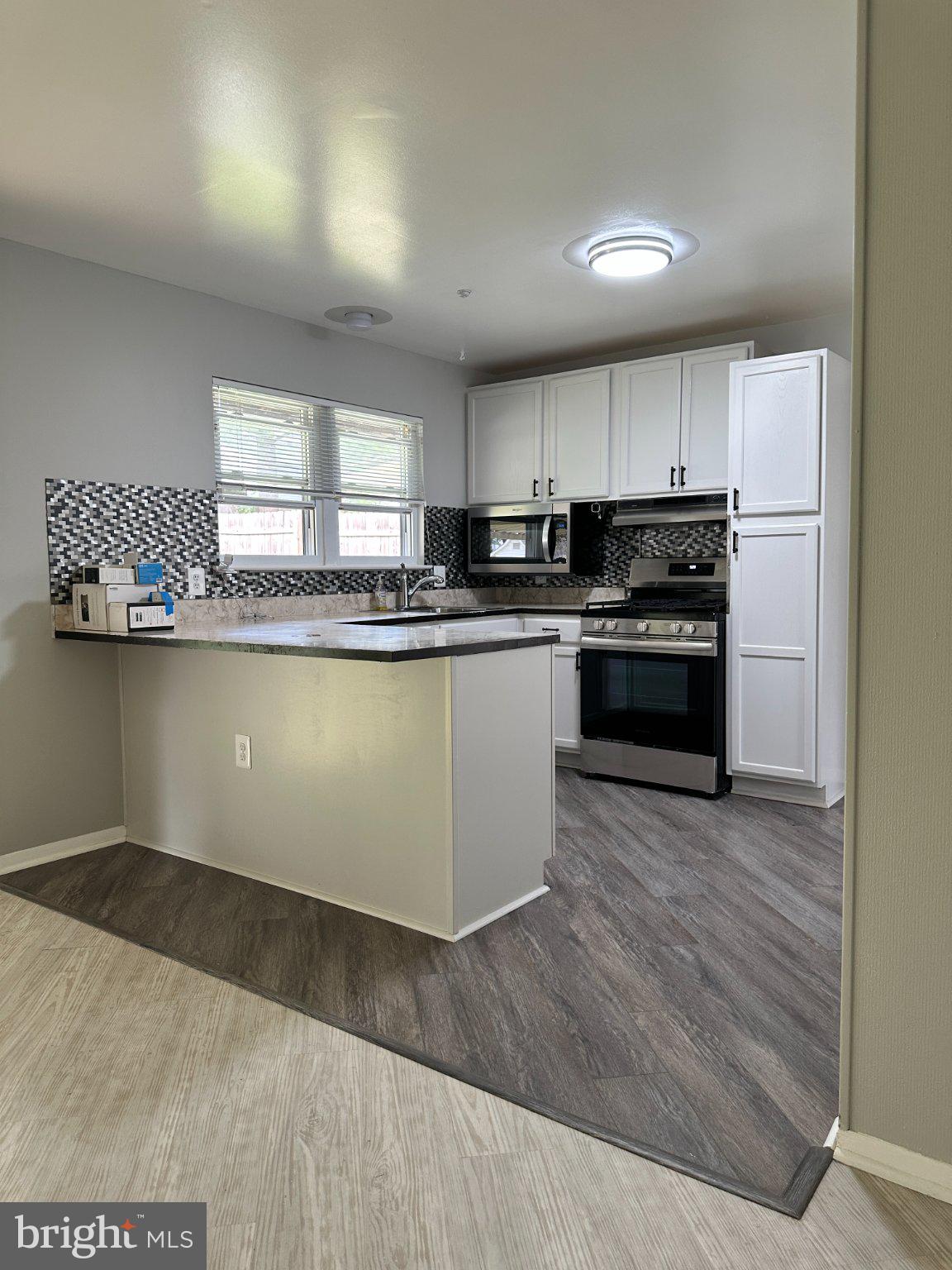 8336 Scotts Level Road Baltimore, MD 21208 - Photo 20 of 55 Modern kitchen with sleek finishes.