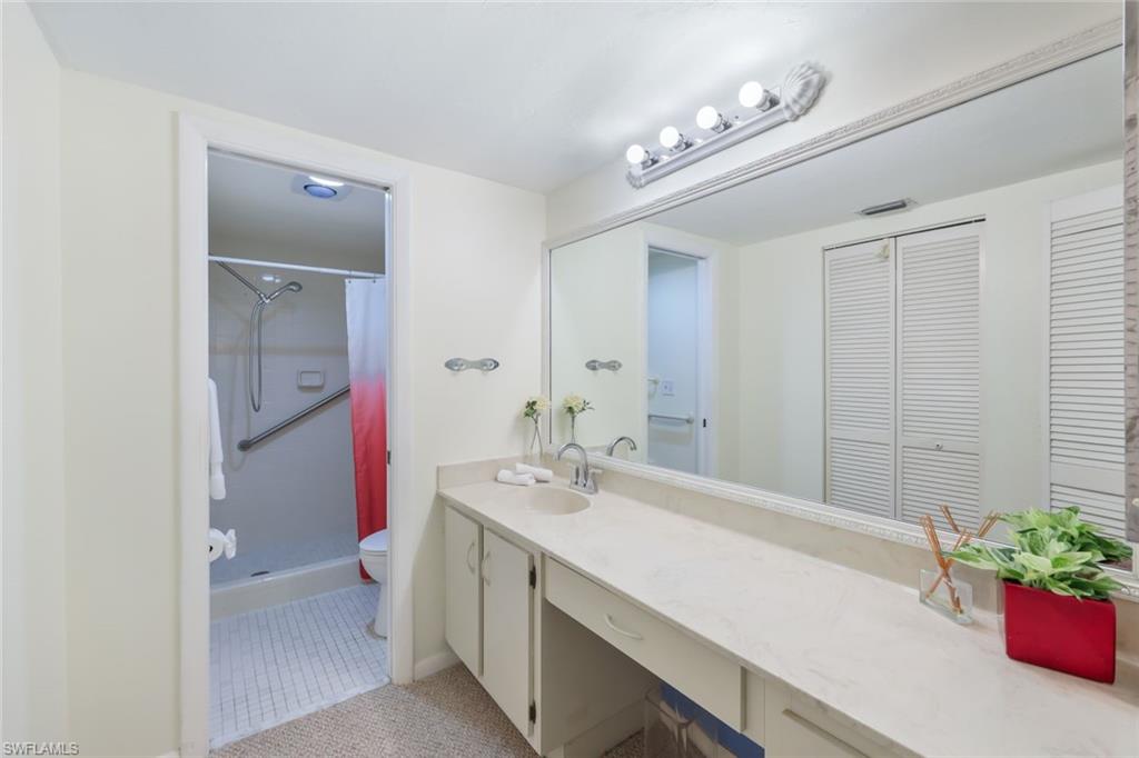 1814 Kings Lake Boulevard, Unit 102 Naples, FL 34112 - Photo 17 of 21 Primary-bathroom with long vanity and walk in shower.