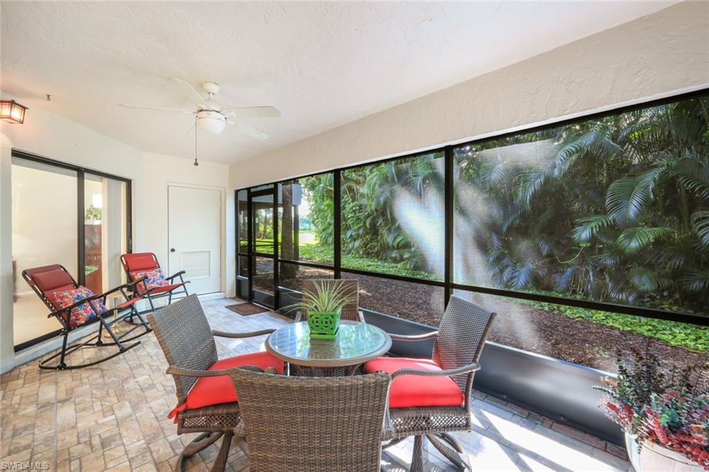 1814 Kings Lake Boulevard, Unit 102 Naples, FL 34112 - Photo 21 of 21 Back lanai with ceiling fan and storage unit