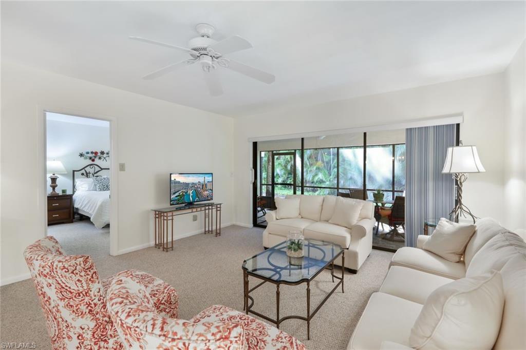 1814 Kings Lake Boulevard, Unit 102 Naples, FL 34112 - Photo 8 of 21 Living room with entrance to the primary-bedroom and back lania