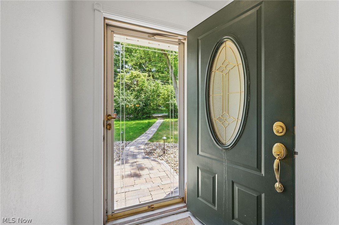 7750 Lewis Road Olmsted Falls, OH 44138 - Photo 6 of 50 Entry door with an oval decorative glass insert and brass hardware