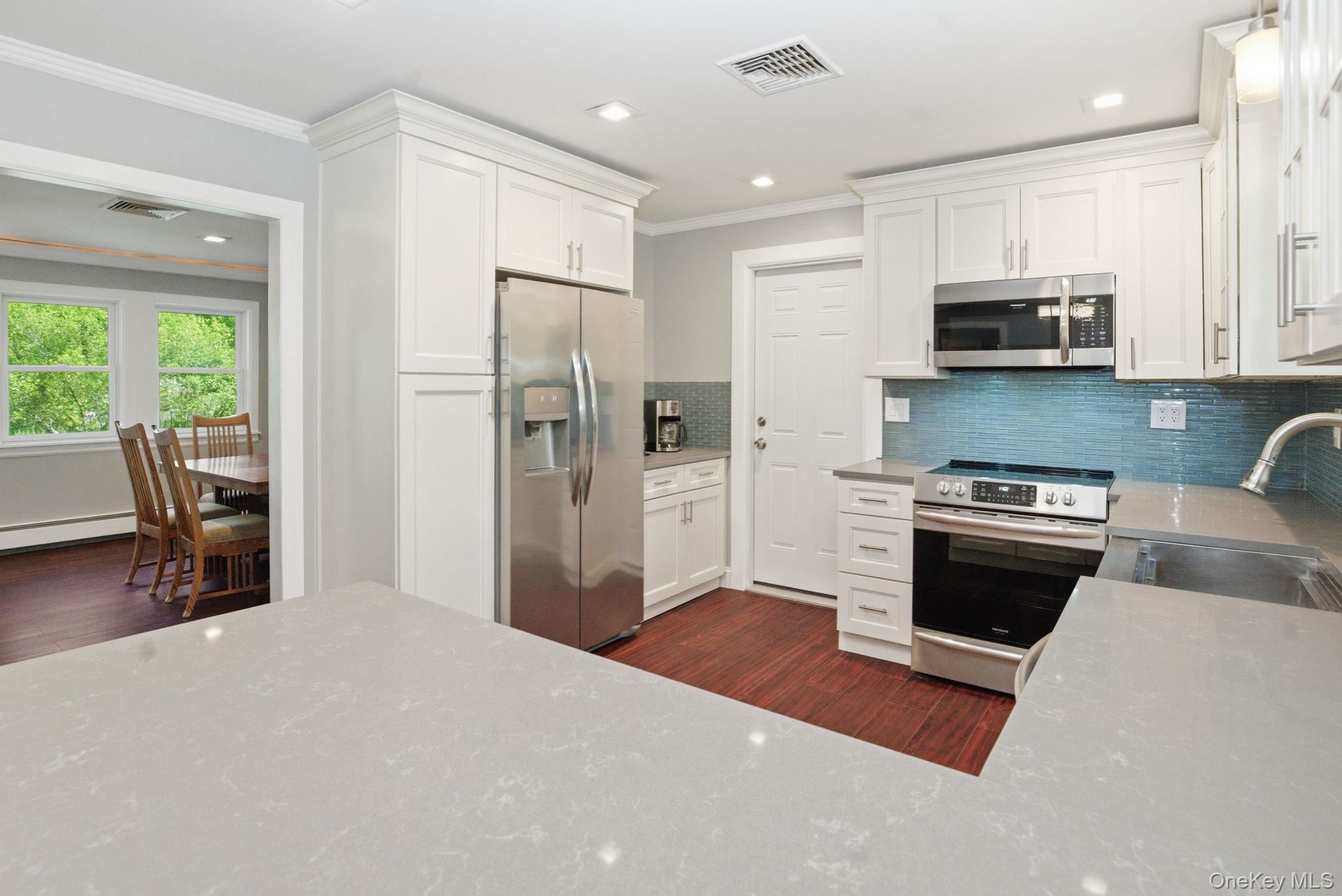 35 Deans Bridge Road Somers, NY 10589 - Photo 9 of 49 Generous counter space and modern finishes open right to the dining room, perfect for cooking and gathering.